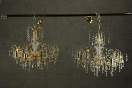 A pair of contemporary gilt brass and Swarovski Spectra crystal drop eight branch chandeliers