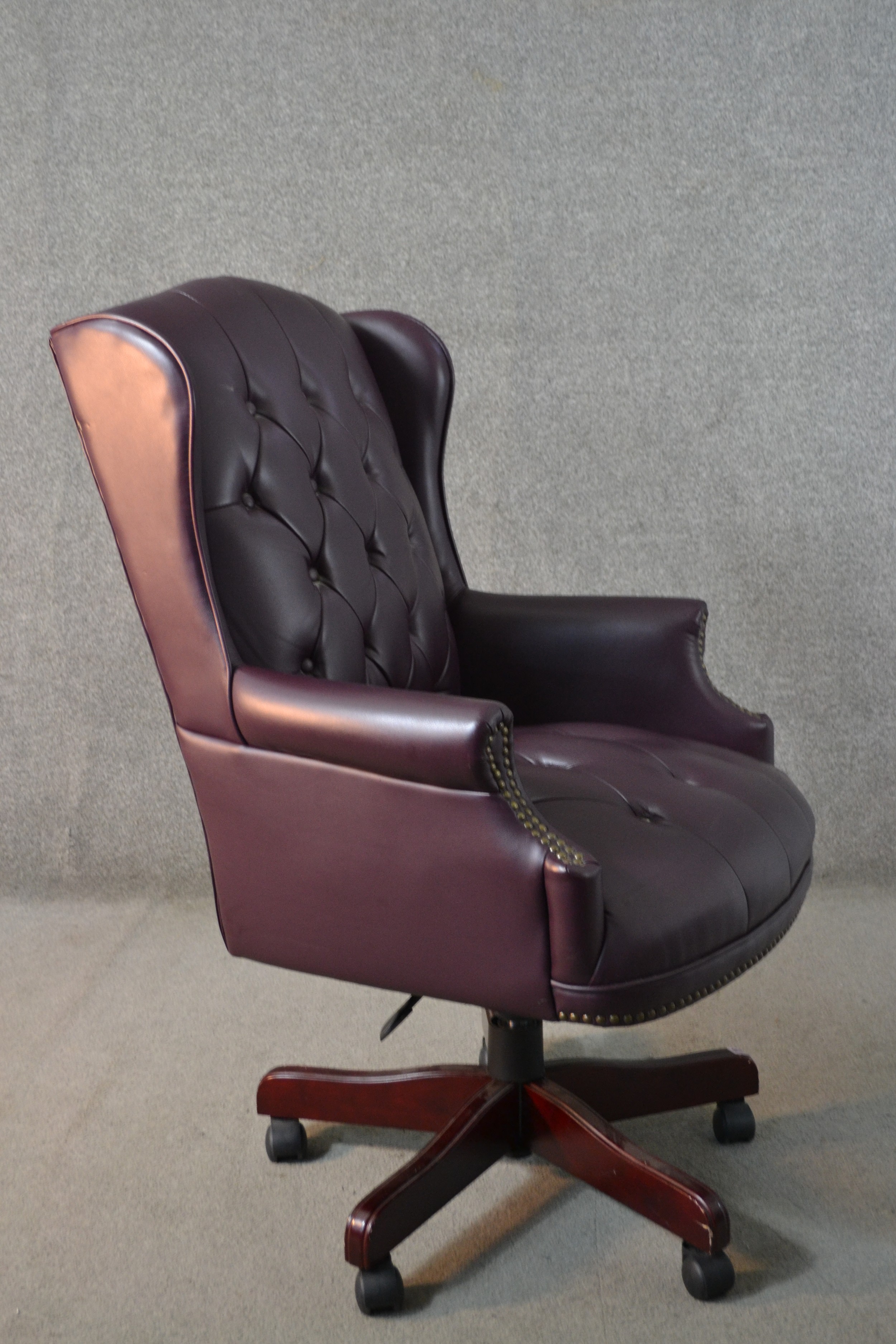 A 20th century wing back swivel office chair, upholstered in burgundy leather, with buttoned back - Image 5 of 13