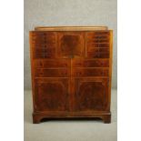 An early 20th century walnut dentists cabinet with a gallery back over a central fall front, flanked