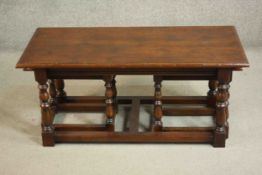 A low antique style oak coffee table and a pair matching joynt stools, the rectangular top with a