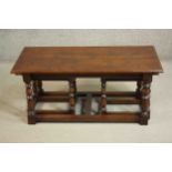 A low antique style oak coffee table and a pair matching joynt stools, the rectangular top with a