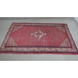 A red ground handmade Persian sarouk rug. L.204 H.130cm