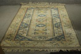 A Beige ground handmade Turkish Milas carpet. L.235 W.162cm.