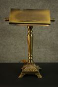 A replica Victorian style banker's brass desk lamp, with a brass shade, a reeded stem on a square