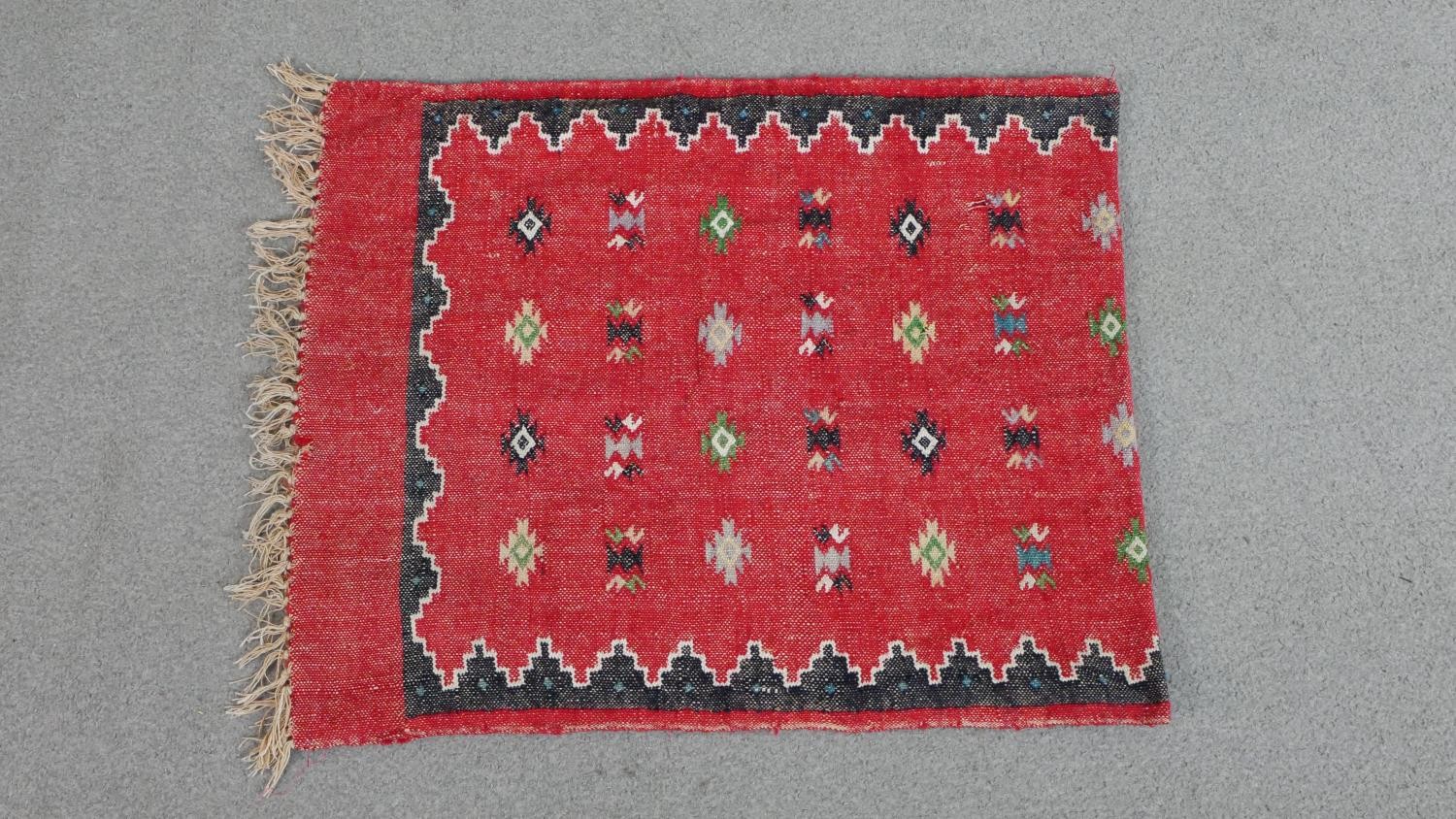 A red ground handmade Kelim rug L.67 W.55cm