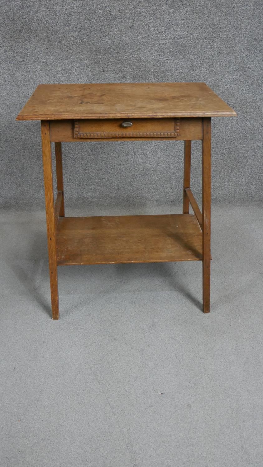An Arts & Crafts oak occasional table, the rectangular top with a moulded edge over a single