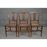 A set of three Edwardian mahogany and line inlaid dining chairs, with a pierced back splat, over a