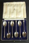 A cased set of six Mappin and Webb silver tea spoons with stylized thistle finials. Hallmarked: M&