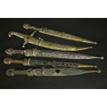 A collection of five 20th century Armenian daggers. The silver plated and brass scabbards with