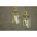 A pair of George III style brass hall lanterns, of hexagonal section, each with two