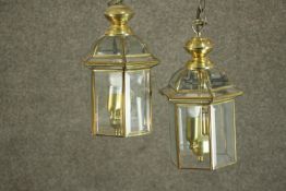 A pair of George III style brass hall lanterns, of hexagonal section, each with two