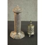 An Indian low grade silver pierced design candle holder with hexagonal base. Stamped silver (base