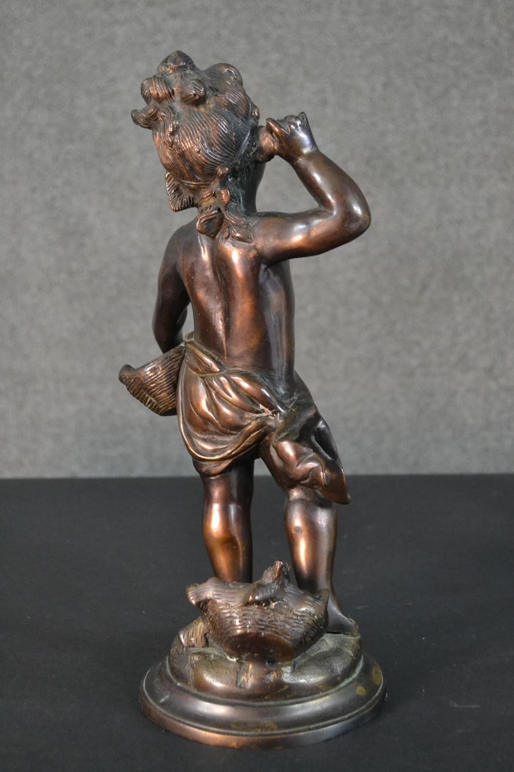 A spelter figure of a classical style putti with a basket of flowers. H.37cm - Image 5 of 8