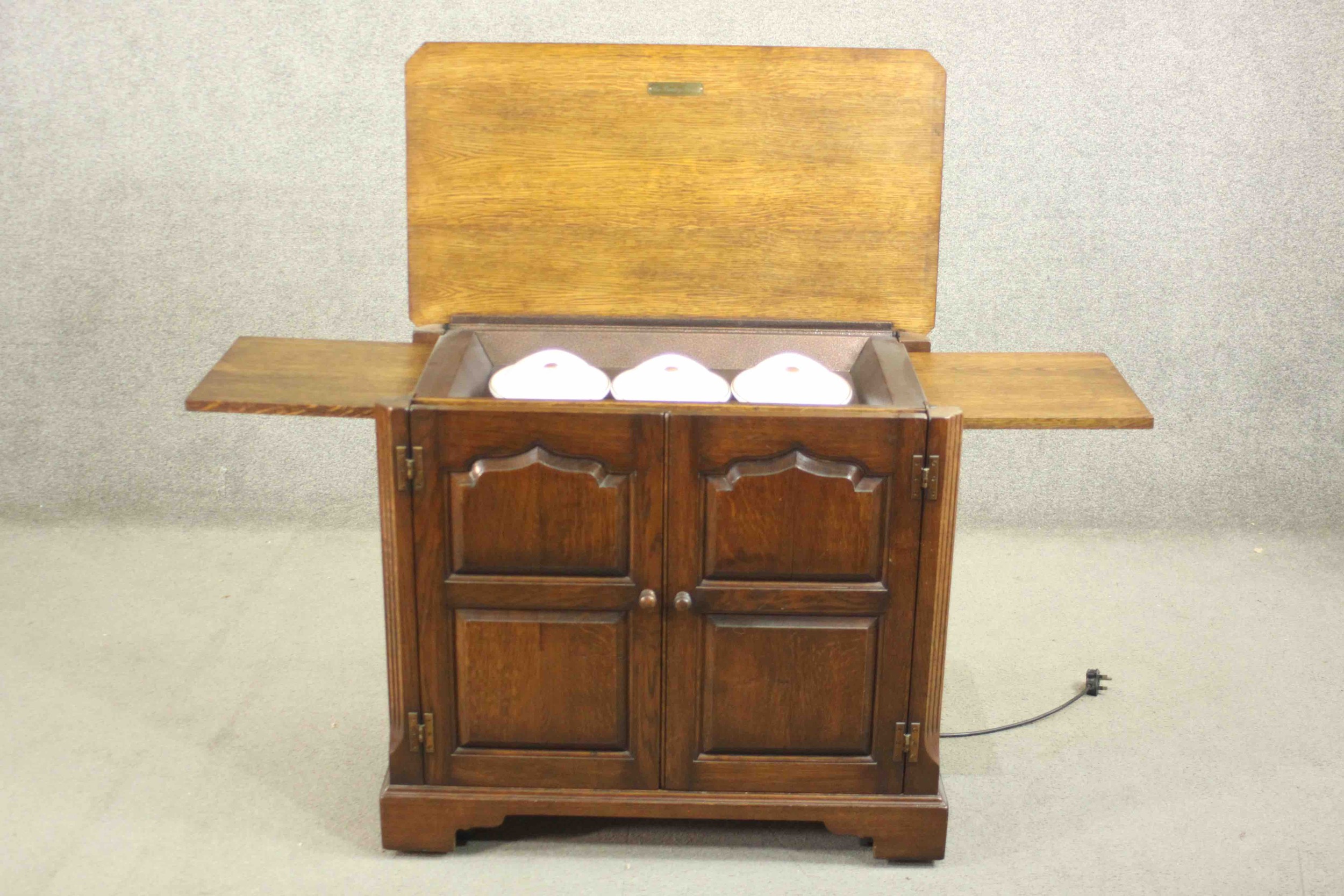 The Burley Butler; an oak heated sideboard electric food warmer, with a rising lid and two - Image 11 of 11