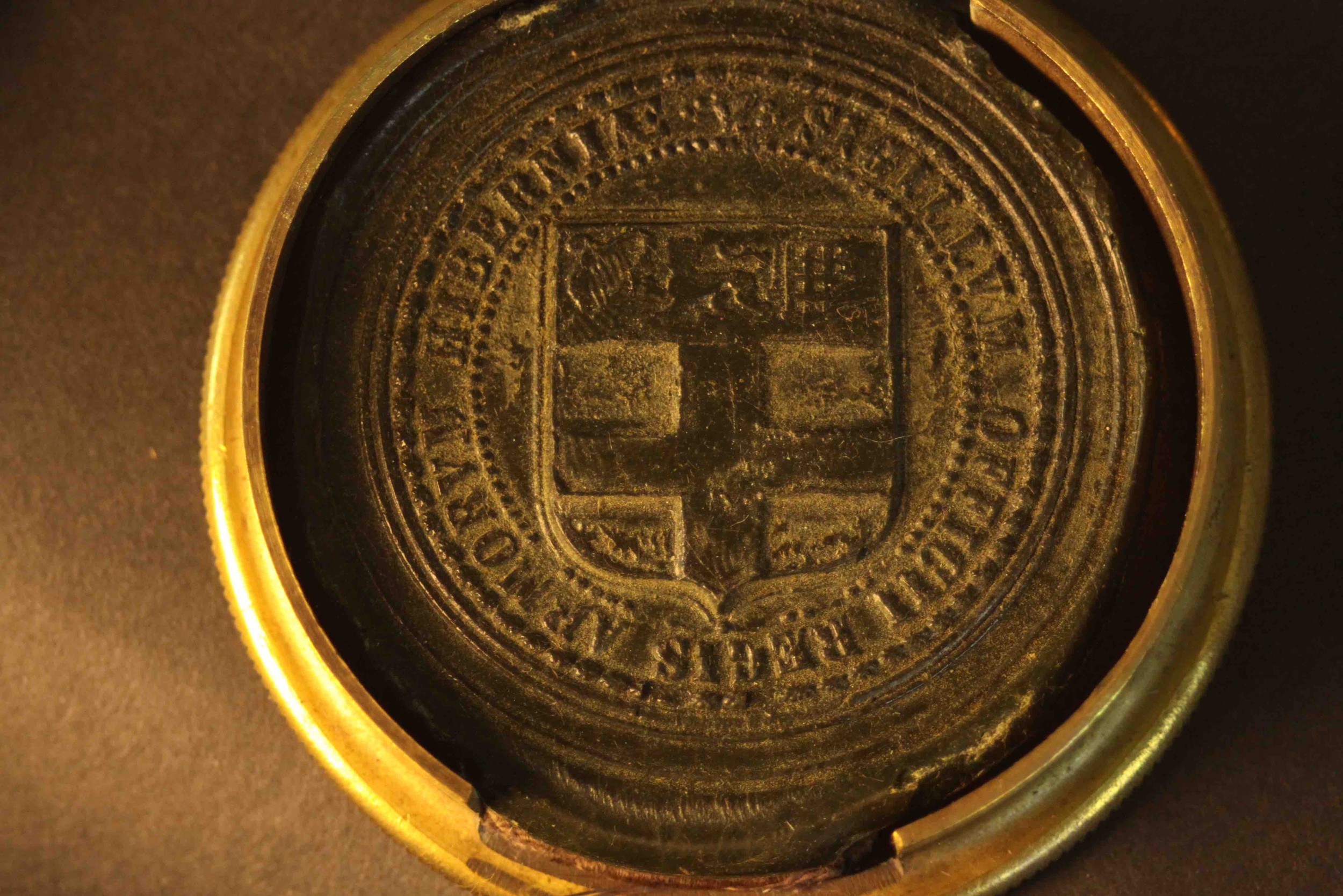 An early 20th century brass embossed box containing an Irish clerical wax seal. H.2.5 Dia.8cm. - Image 5 of 6
