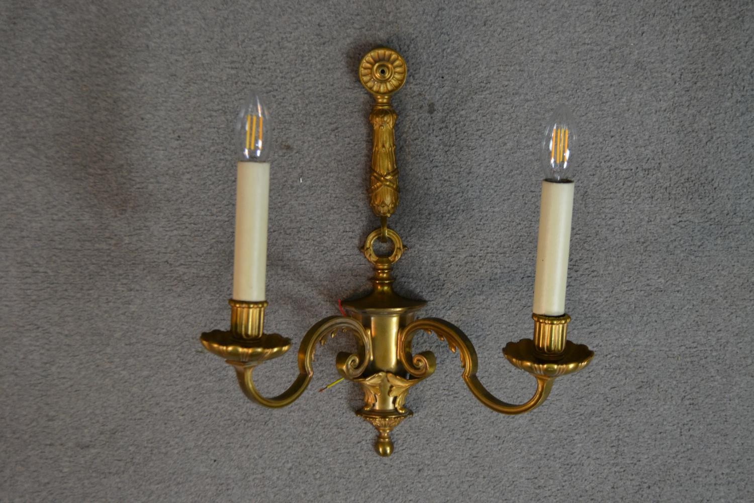 A pair of gilt metal two branch regency style wall sconces with laurel leaf and ribbon motifs. H. - Image 2 of 4