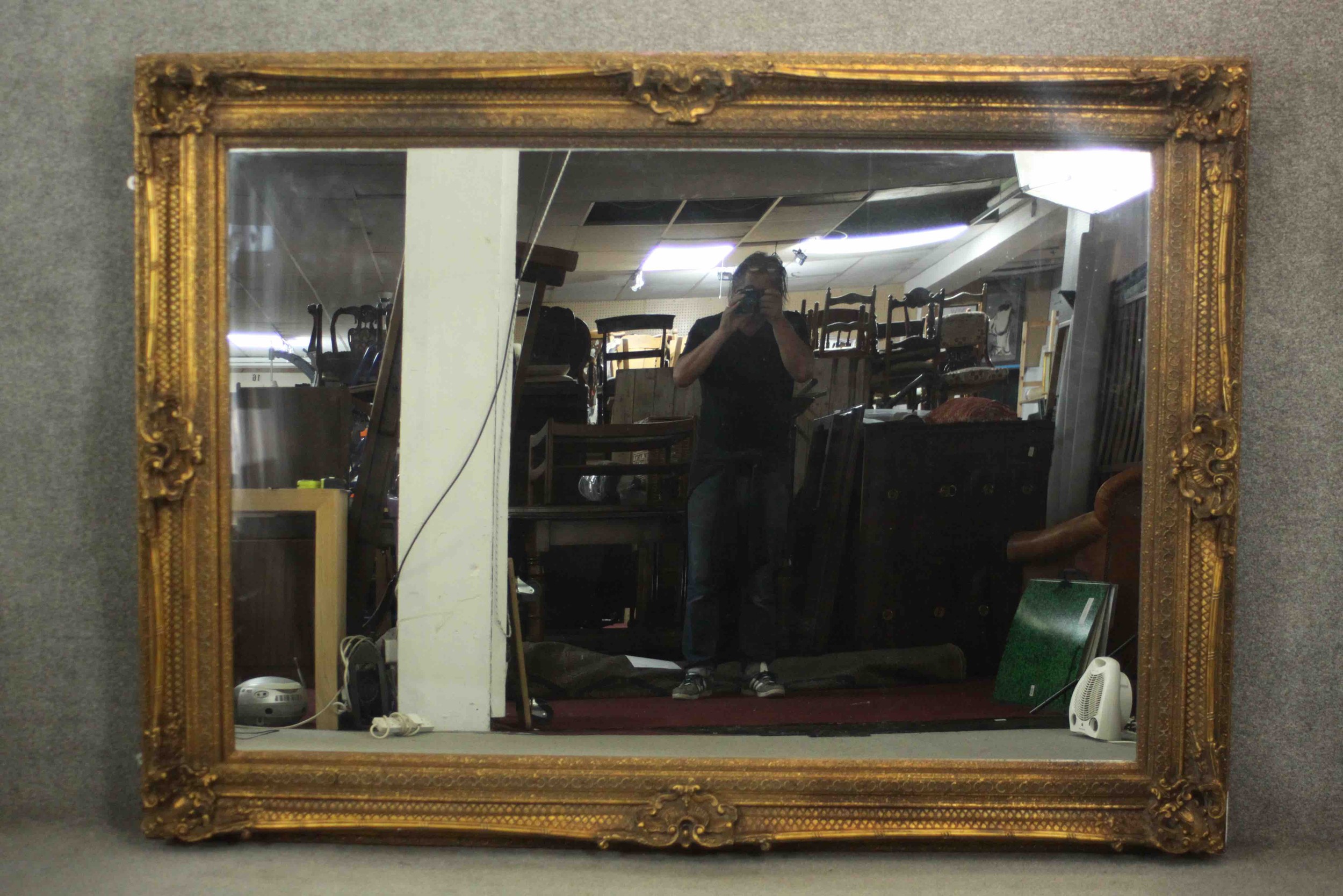 A large and decoratively framed gilt pier mirror in the Rococo style. H.160 W.220cm.