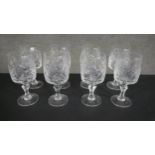A set of eight hand cut crystal wine glasses. H.18 W.8cm.