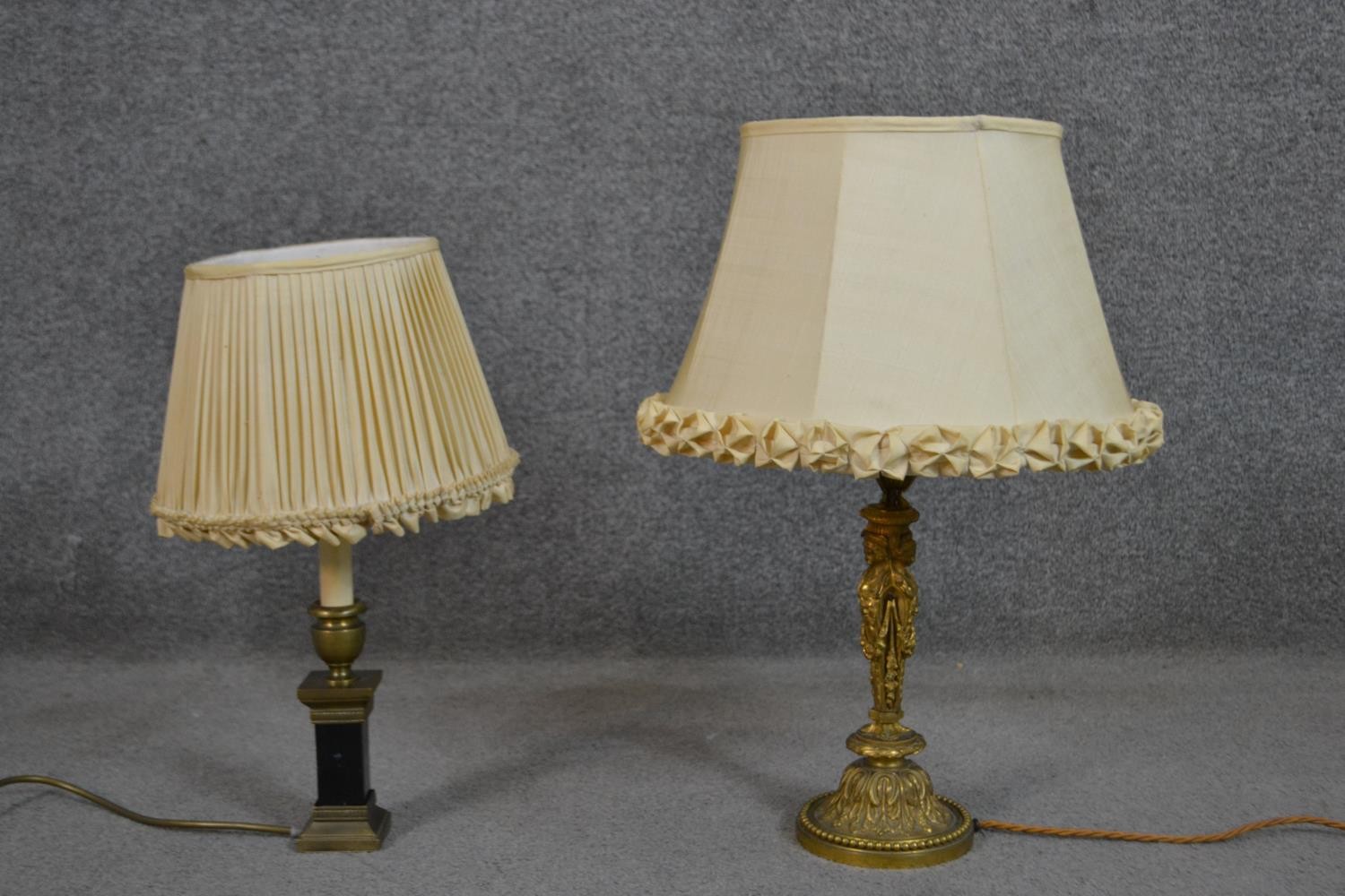 Two 19th century table lamps, one gilt metal with figural design and the other black marble