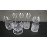 A collection of nine hand cut crystal drinking glasses, including three hand cut sherry glasses with