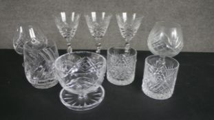 A collection of nine hand cut crystal drinking glasses, including three hand cut sherry glasses with