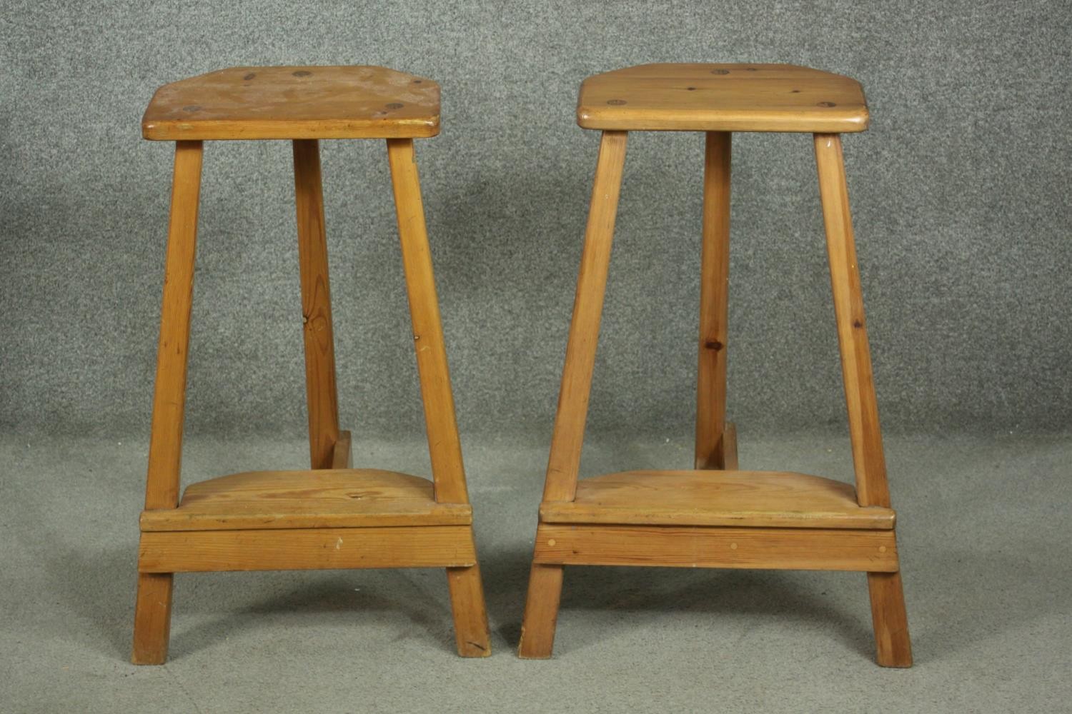 A pair of 20th century pine bar stools, the seat with two canted corners, on splayed square