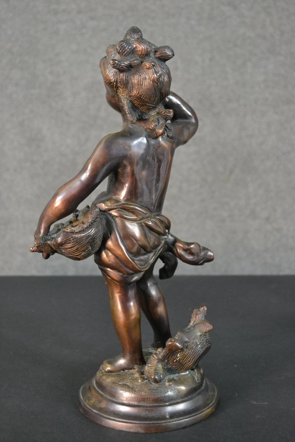 A spelter figure of a classical style putti with a basket of flowers. H.37cm - Image 6 of 8