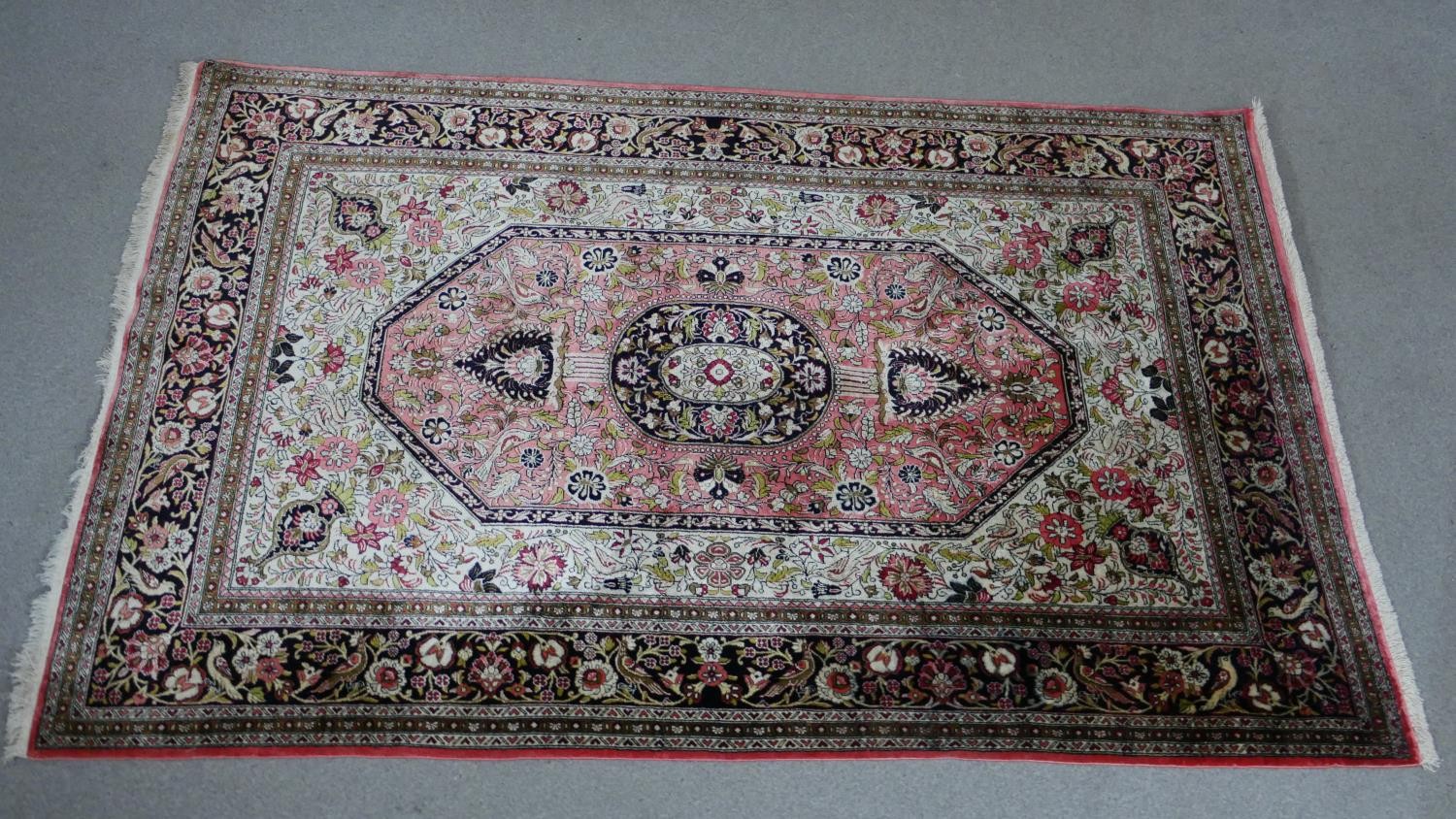 A handmade cream ground Persian silk Kum rug. L.160 W.102cm