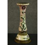 An early 20th century relief poppy design ceramic planter stand on cream ground and green detailing.