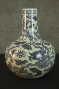 A 20th century Chinese ceramic blue and white hand painted dragon and cloud design bottle vase.