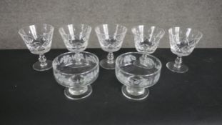 A set of five hand cut crustal sherry glasses along with two etched glass pudding glasses. H.11 W.