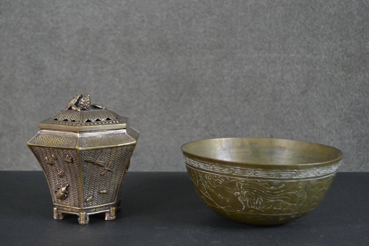 A Chinese brass woven design lidded box with relief insects and cicada finial along with an engraved