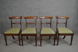 A set of four circa 1830's rosewood bar back dining chairs with green upholstered drop in seats on