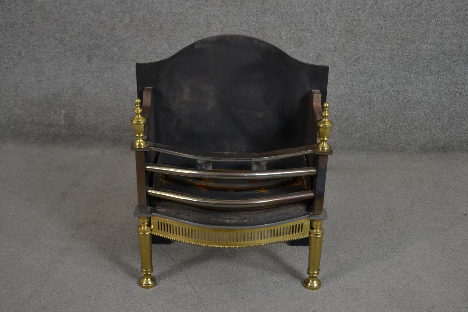 A Victorian cast iron and brass fire basket with pierced design. H.59 W.47 D.27cm