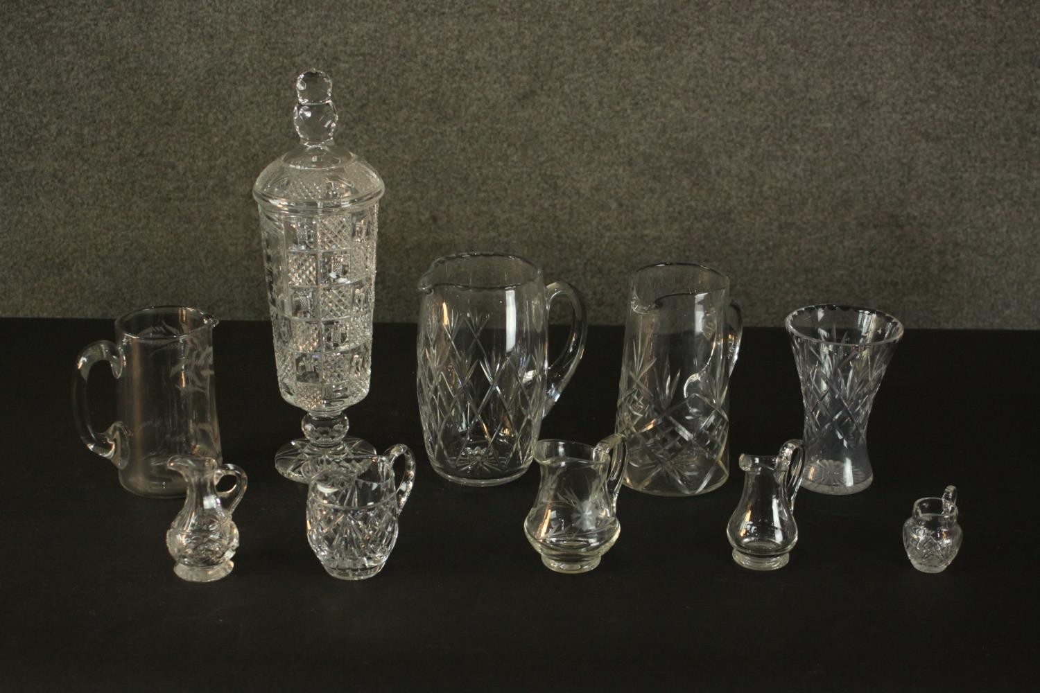 A collection of cut crystal and glass, including a large cut crystal lidded jar, various size jugs