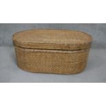 A wicker box of oval form. H.95 W.112 D.73cm