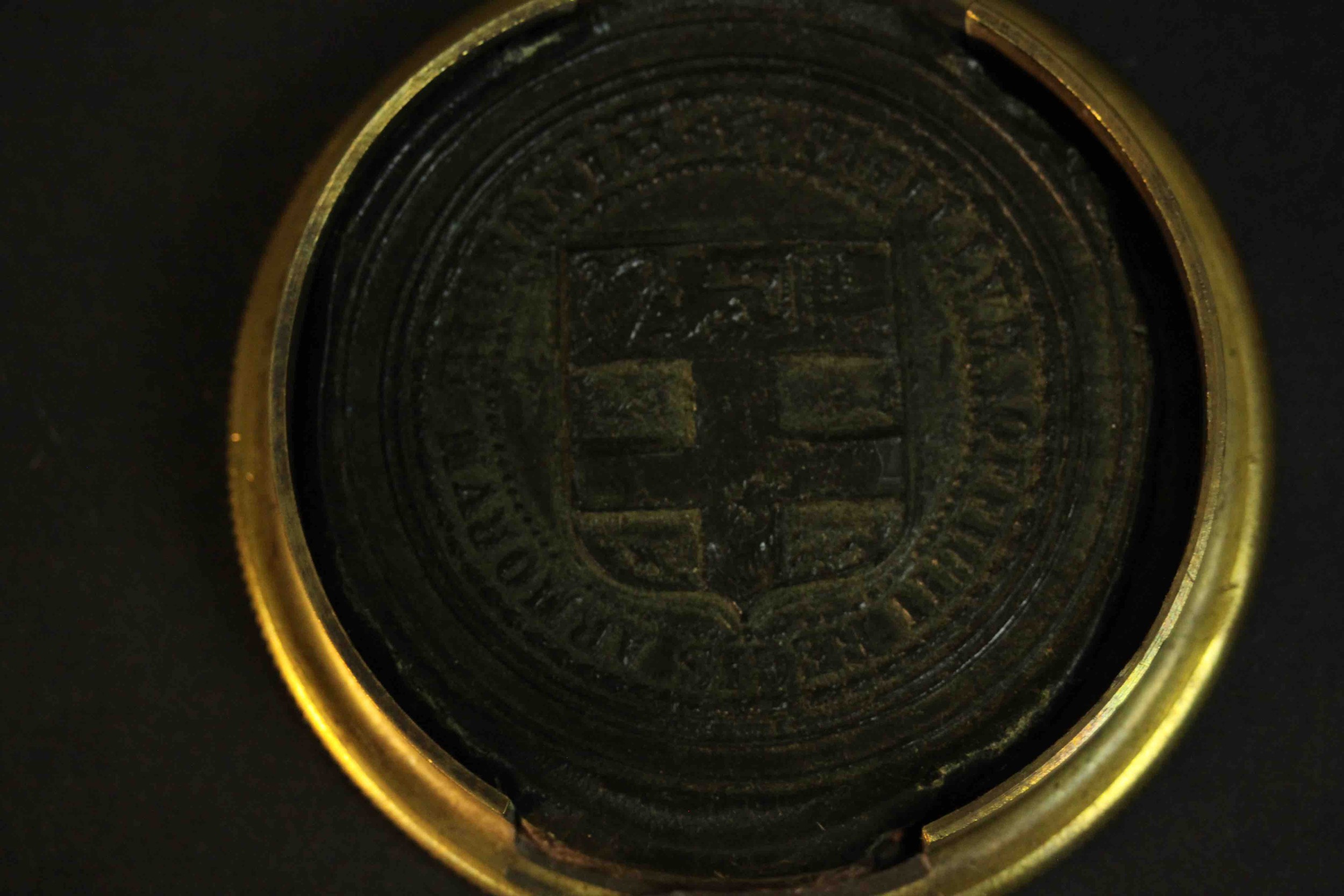 An early 20th century brass embossed box containing an Irish clerical wax seal. H.2.5 Dia.8cm. - Image 4 of 6