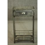 An industrial steel cabinet, with a single drawer over a divider, the sides with a lattice mesh,
