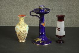 A Doulton Lambeth slater vase with floral design, a Woods Golden Moon painted candle stick and a