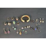 A collection of silver and vintage jewellery including a pair of purple paste set silver earrings, a