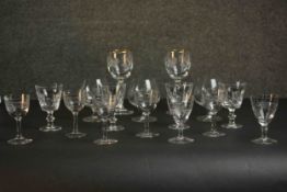 A collection of sixteen hand cut glass and crystal glasses, including a set of four engine decorated