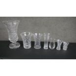 A collection of seven glass and hand cut crystal vases, including a large trumpet design heavy