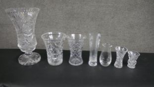 A collection of seven glass and hand cut crystal vases, including a large trumpet design heavy