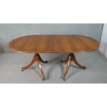 A George III style yew wood D-end dining table, with a cross banded top and additional leaf, on