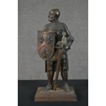 A cast iron fire companion stand in the form of a knight, holding a shield with three fleur de