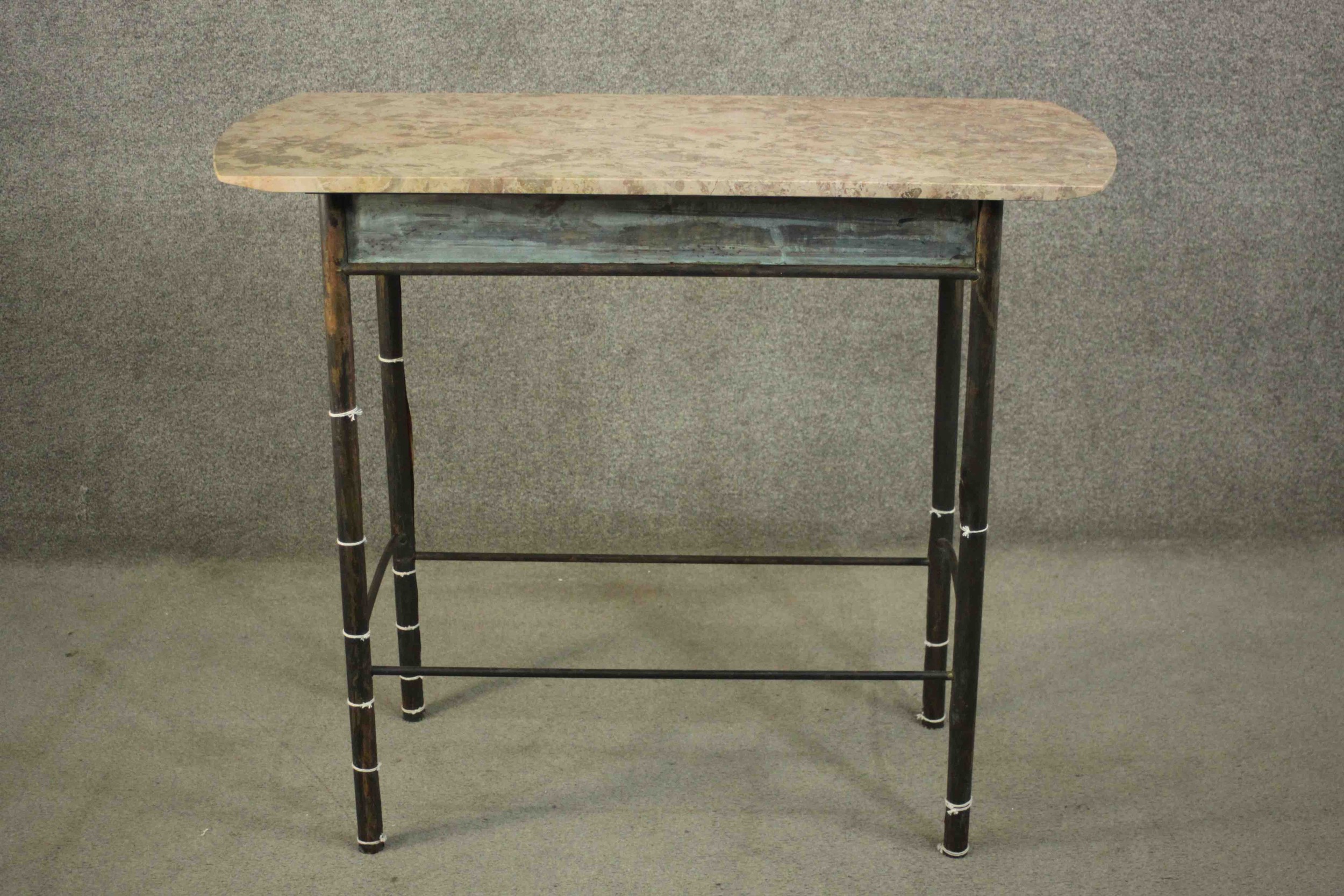 A continental side table. with a marble top, on a bronze base with cylindrical legs joined by