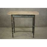 A continental side table. with a marble top, on a bronze base with cylindrical legs joined by