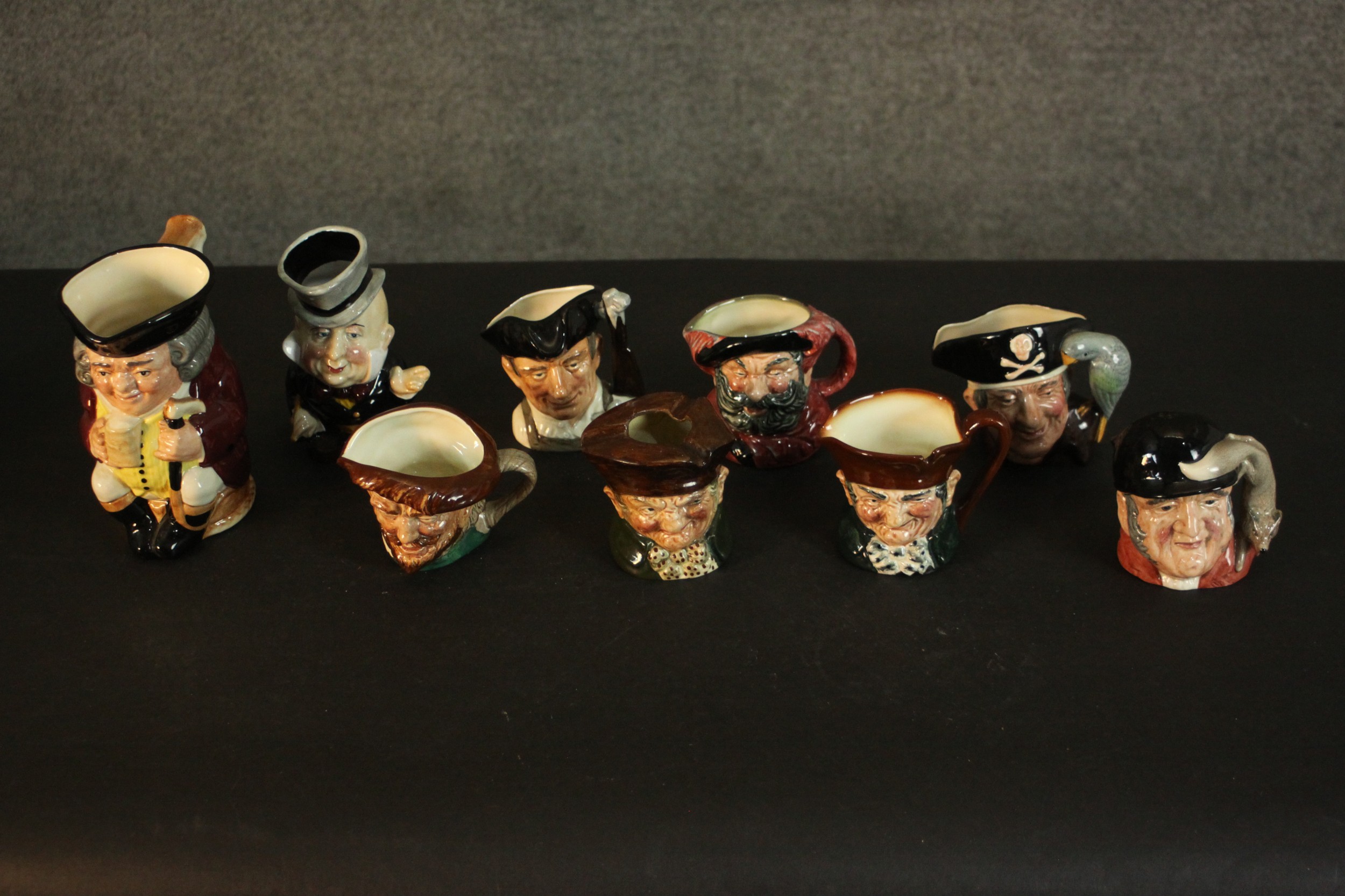 A collection of nine hand-painted Toby jugs, makers marks to the bases. H.16 W.14cm. (largest)