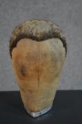 A late 19th/early 20th century wig maker's (perruquier's) dummy head, the neck with a metal