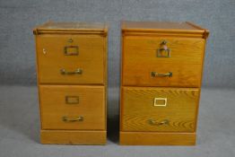 Two similar mid 20th century oak filing cabinets, each with two drawers and on a plinth base. H.72